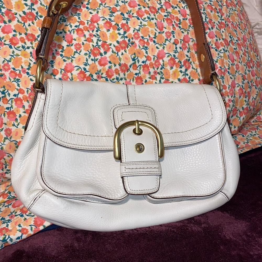 White woman’s Coach purse